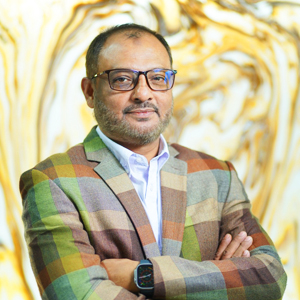 Portrait of Jahirul Kabir Chowdhury (Shiru) in a formal suit